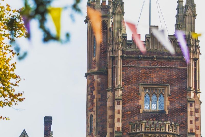 A detail of the red brick Lanyon building with multi-coloured bunting